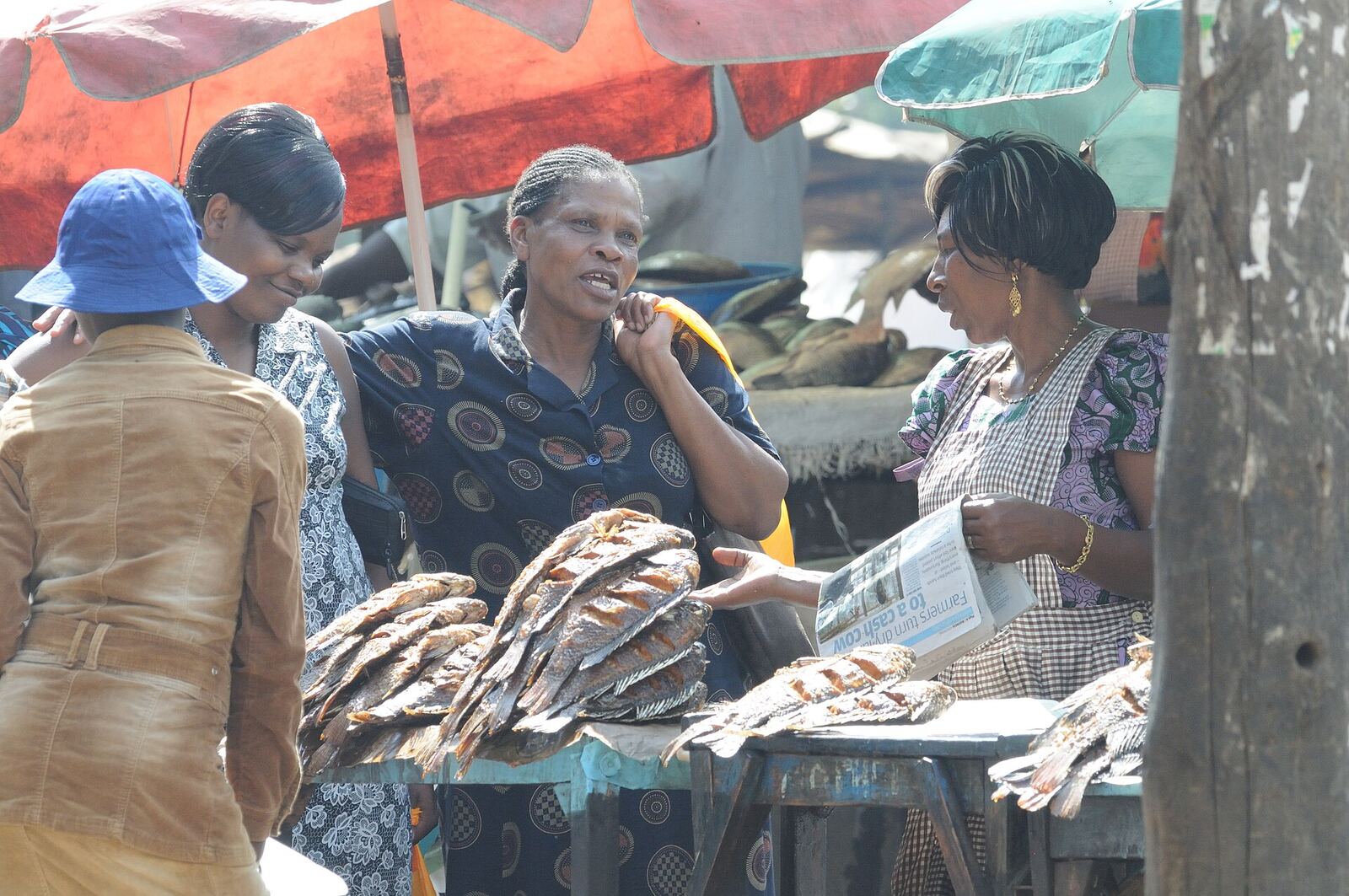 Women talking at a dried-fish stall in a Kisumu market