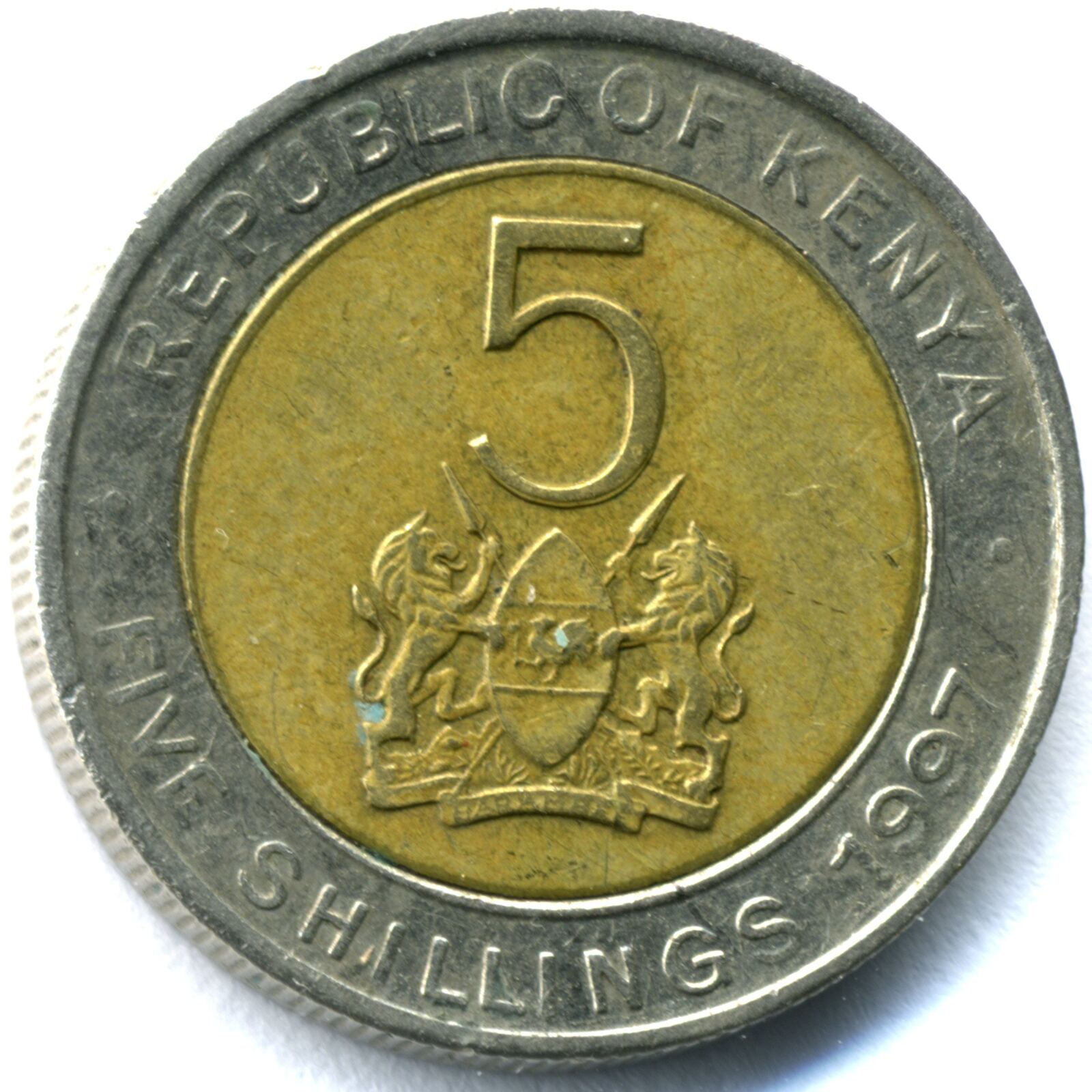 A Kenyan five-shilling coin showing the coat of arms