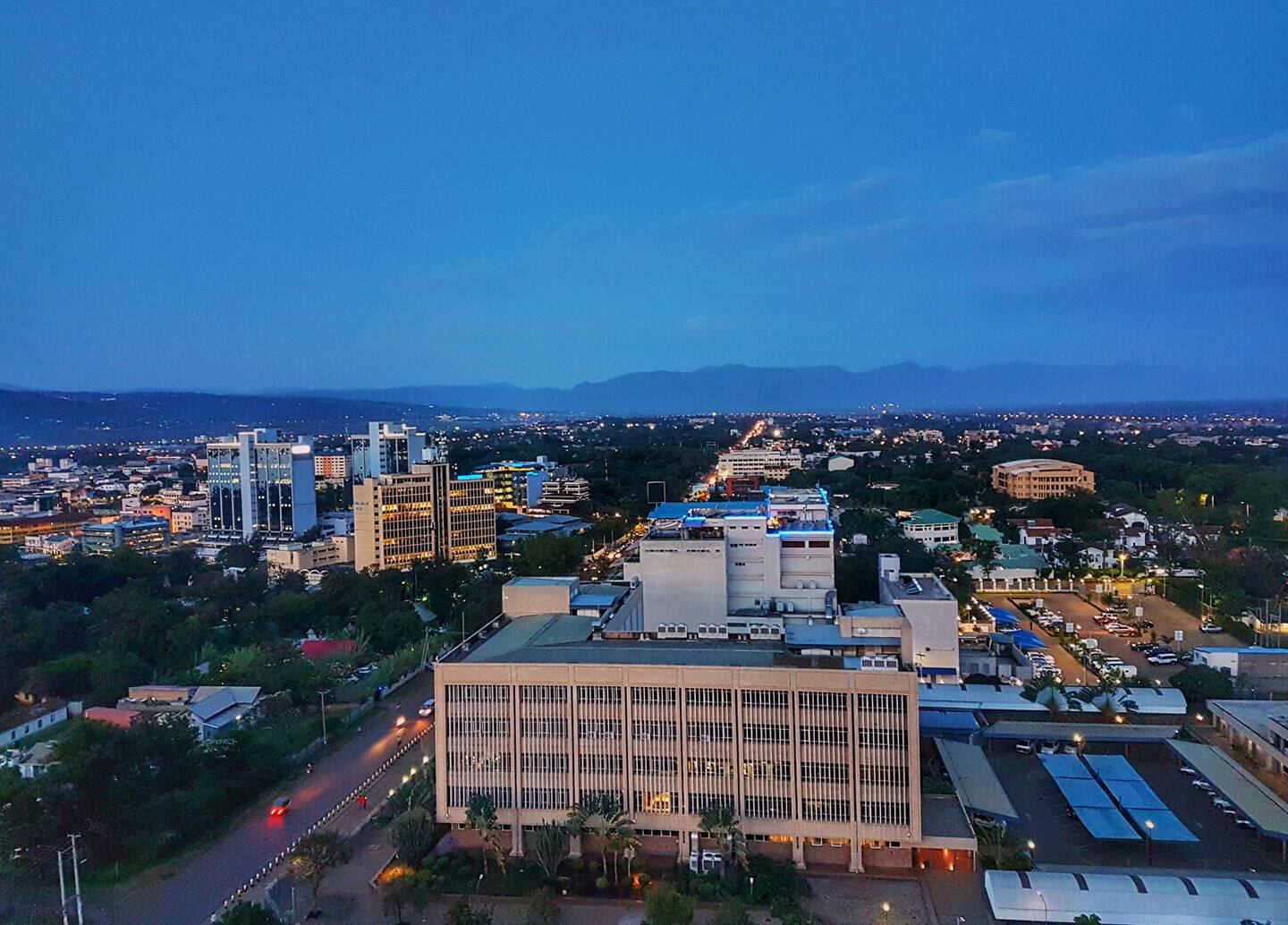 Kisumu at dusk, seen from above, with the hills beyond